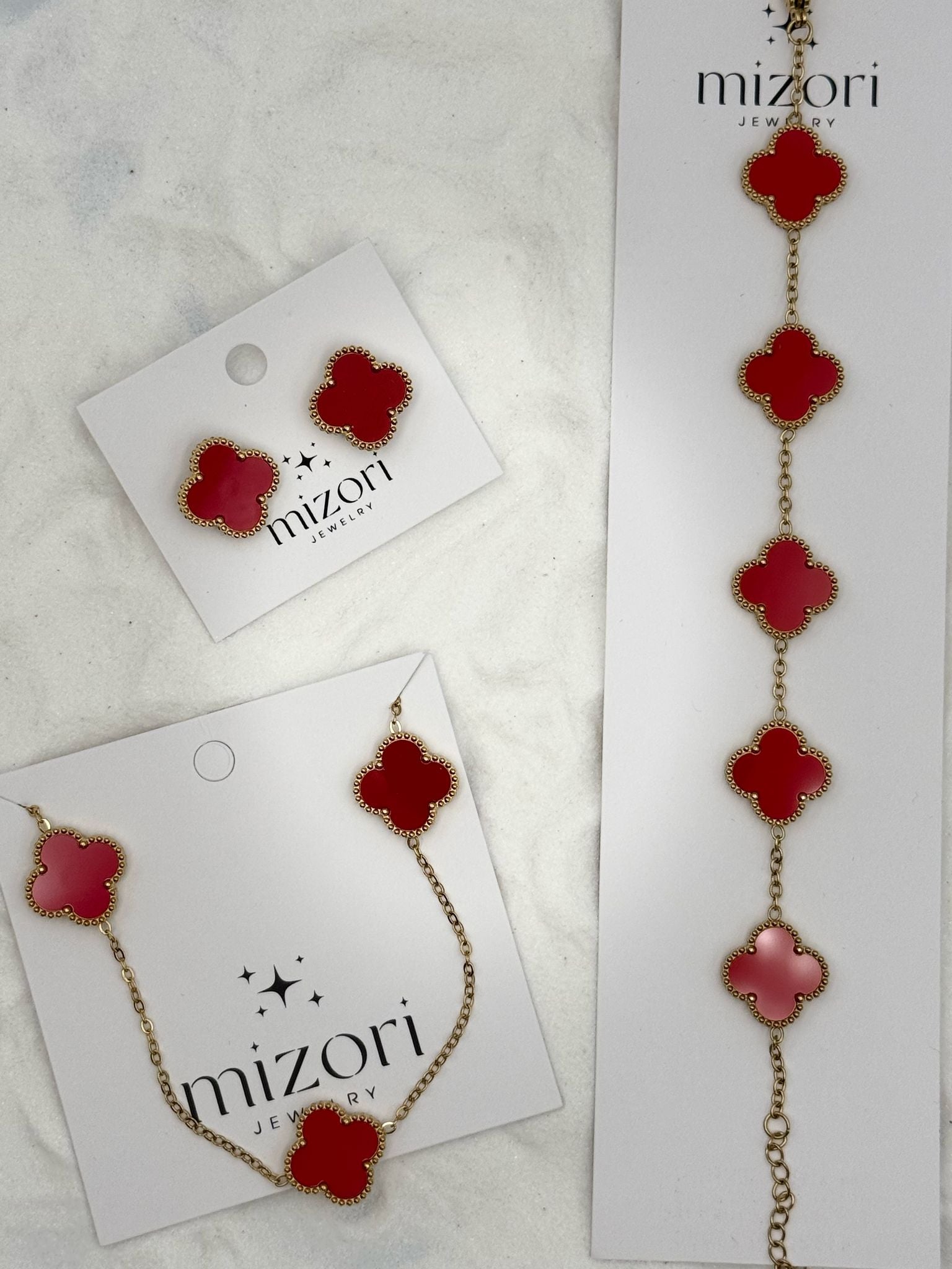 Mizori Jewelry red and gold stainless steel clover necklace and bracelet set, elegant minimalist women’s fashion accessories.