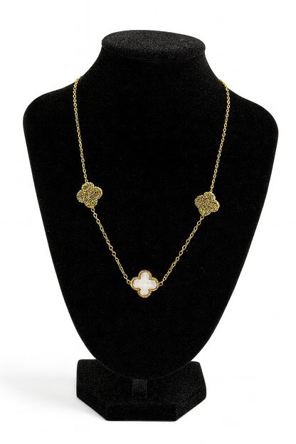 Mizori Jewelry stainless steel gold necklace with 13mm white clover and crystal clovers displayed on stand – water resistant, elegant design.