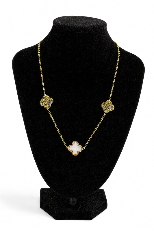 Mizori Jewelry stainless steel gold necklace with 13mm white clover and crystal clovers displayed on stand – water resistant, elegant design.