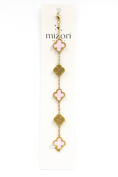 Mizori Jewelry stainless steel gold bracelet with three 13mm pink clovers and two crystal clovers, water resistant and tarnish resistant.
