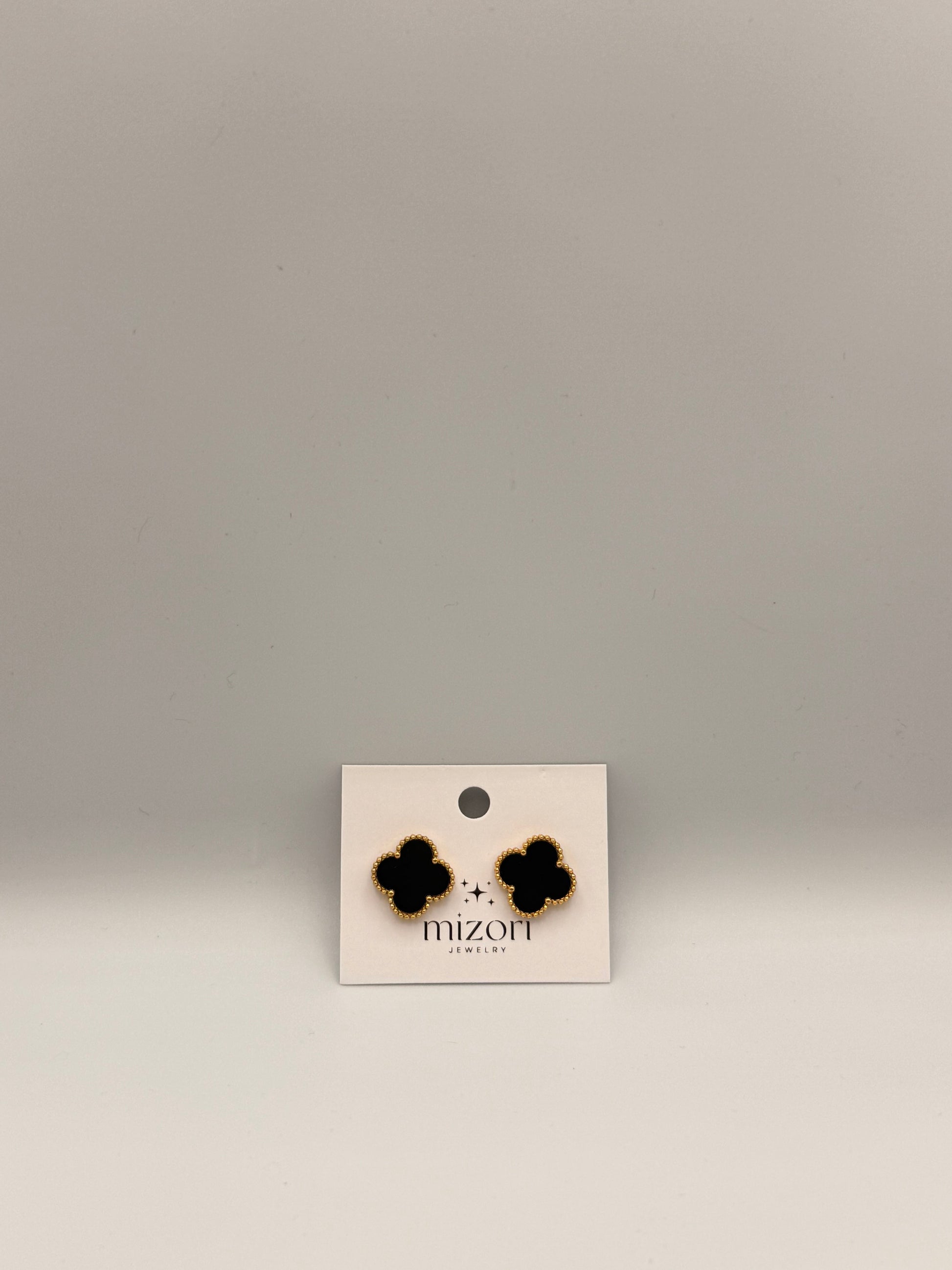 Elegant Mizori Jewelry stainless steel clover earrings in black and gold, minimalist modern design, hypoallergenic women’s fashion jewelry.