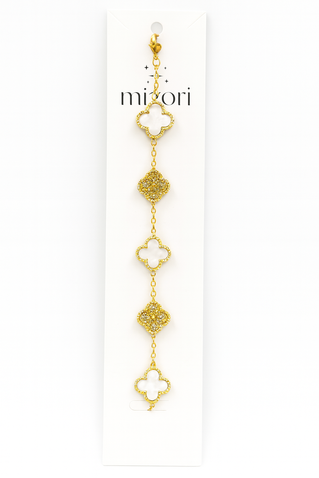 Mizori Jewelry stainless steel gold bracelet with three 13mm white clovers and two crystal clovers, water resistant and tarnish resistant.