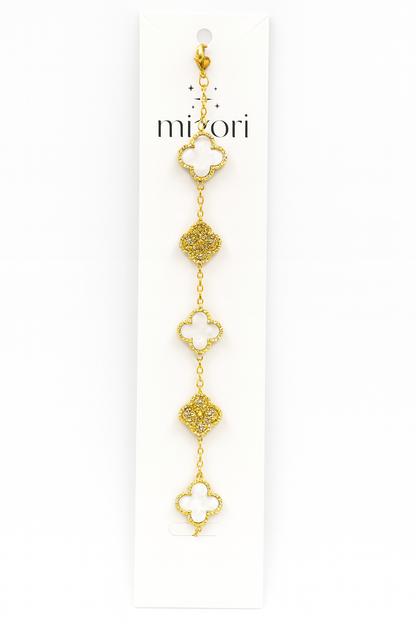 Mizori Jewelry stainless steel gold bracelet with three 13mm white clovers and two crystal clovers, water resistant and tarnish resistant.